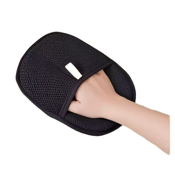 Black dual-sided pet grooming glove worn on a hand